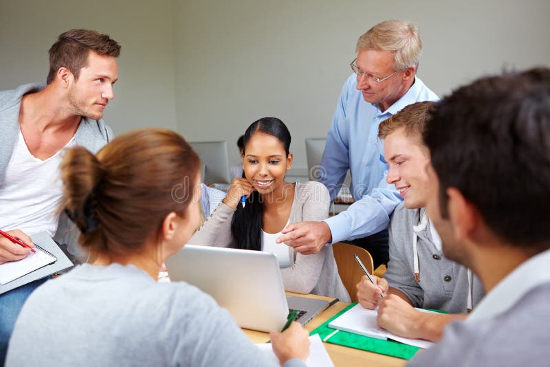 Teacher with students together in a college class. Teacher with students together in a college class