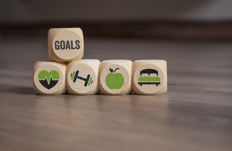 Cubes dice with your goals, health care, fitness training, nutrition and sleep on wooden background. Cubes dice with your goals, health care, fitness training, nutrition and sleep on wooden background