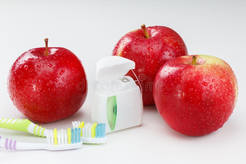 Les dents dentaires floss, brosse à dents et pomme rouge images libres de droits Les dents dentaires floss, brosse à dents et pomme rouge images libres de droits