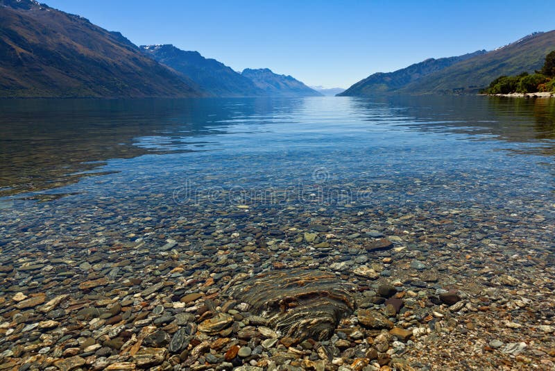 View of the clear waters and mountains at lake Wakatipu, New Zealand. View of the clear waters and mountains at lake Wakatipu, New Zealand