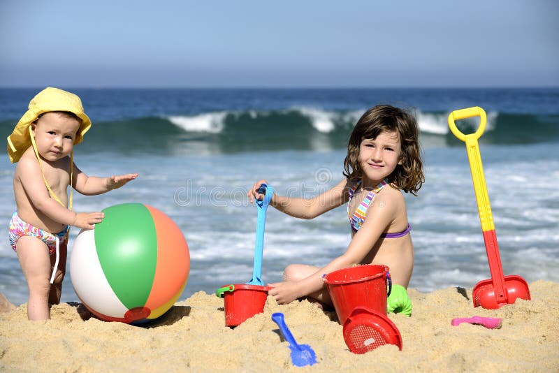 Summer vacation: Kids playing with beach toys in the sand. Summer vacation: Kids playing with beach toys in the sand