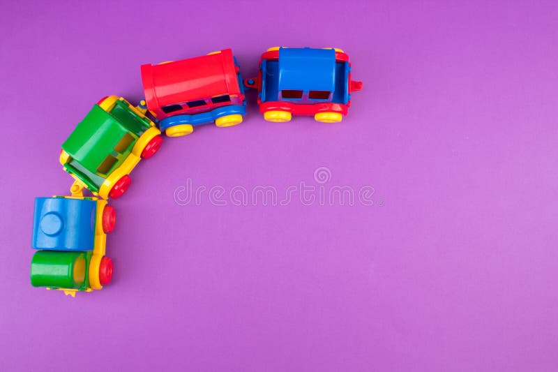 Children's toy, a multi-colored steam locomotive on a purple background. For the development of the child. Children's toy, a multi-colored steam locomotive on a purple background. For the development of the child