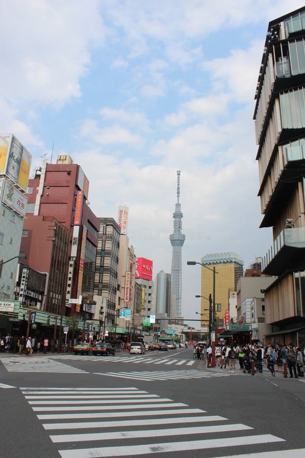 People are waiting on the crosswalk in Japan, vehicles are waiting too on red light. People are waiting on the crosswalk in Japan, vehicles are waiting too on red light.