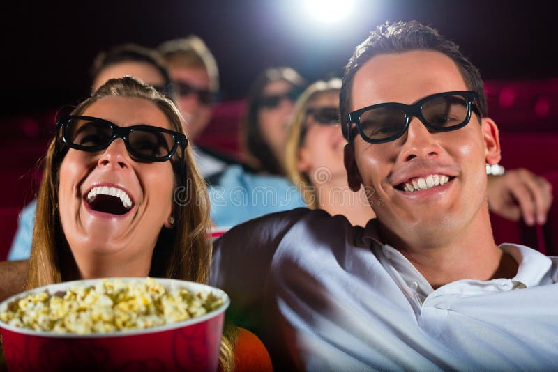 Young people watching 3d movie at movie theater having fun. Young people watching 3d movie at movie theater having fun