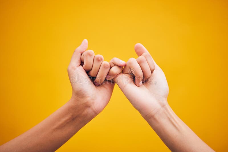 People, hands and pinky promise in studio with trust, help or hope for reconciliation on yellow background. Finger, emoji and deal by friends with secret, gesture and support expression or solidarity. People, hands and pinky promise in studio with trust, help or hope for reconciliation on yellow background. Finger, emoji and deal by friends with secret, gesture and support expression or solidarity.