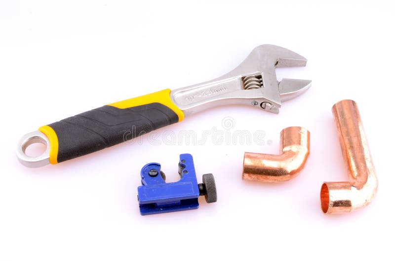 Plumber's tools including wrench, copper pipe and pipe cutter. Plumber's tools including wrench, copper pipe and pipe cutter.