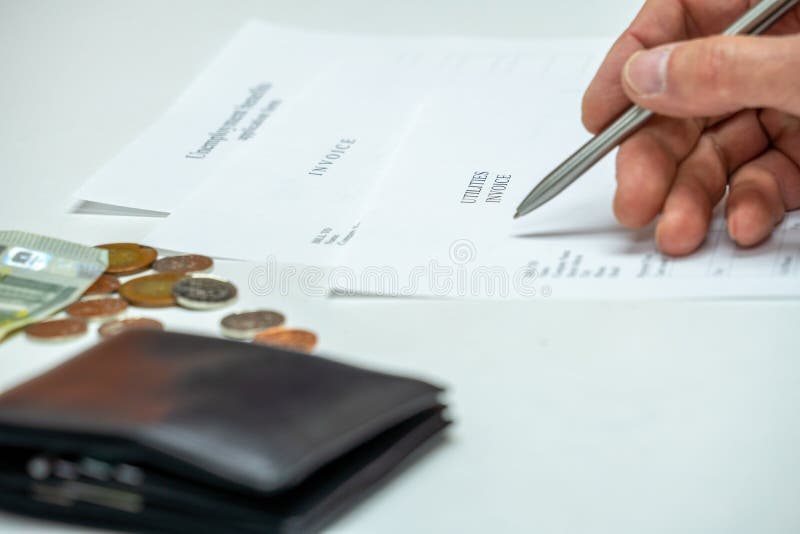 Man signs a utilities invoice with a ballpoint pen in the office. Man signs a utilities invoice with a ballpoint pen in the office