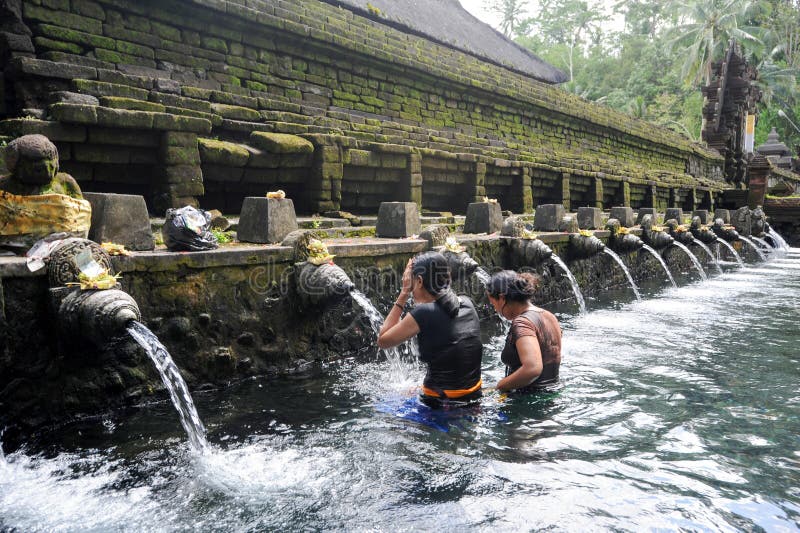 Les voyageurs priant et prennent un bain à l'eau de source sainte photos libres de droits Les voyageurs priant et prennent un bain à l'eau de source sainte photos libres de droits