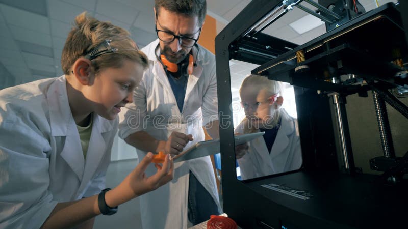 les éléments 3D-printed obtiennent ont observé par des écoliers et un chercheur