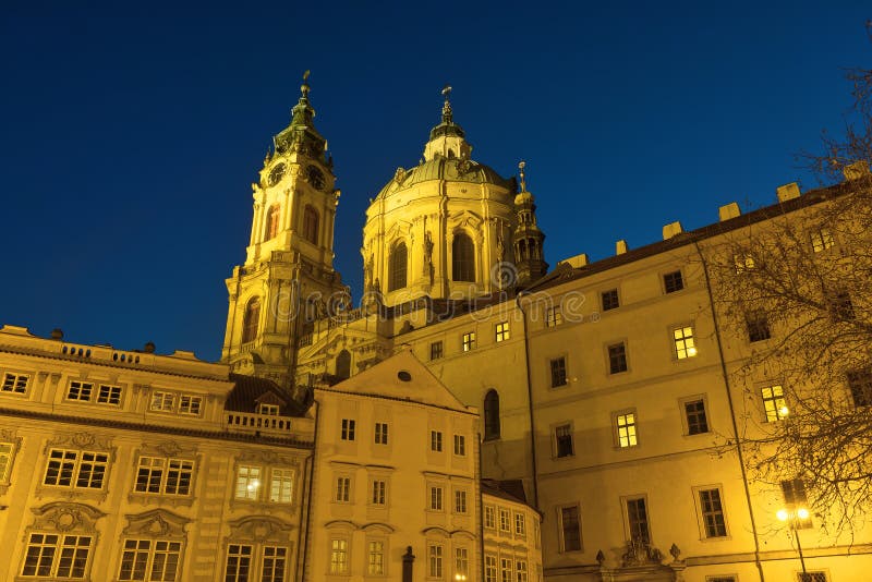 Sunset with crystal clear sky without a single cloud along with night lighting created a perfect scenery in Ukrainian national colours. Lesser Town Square with St Nicholas cathedral in Prague, Czech Republic. Sunset with crystal clear sky without a single cloud along with night lighting created a perfect scenery in Ukrainian national colours. Lesser Town Square with St Nicholas cathedral in Prague, Czech Republic