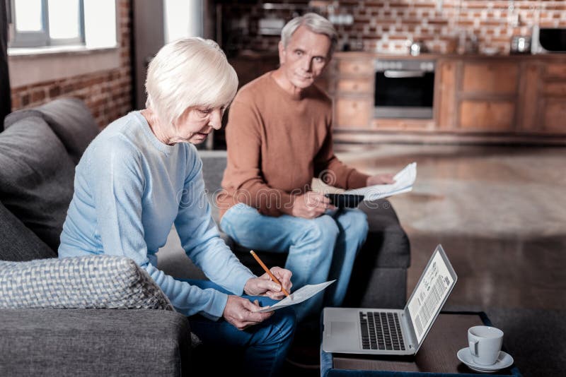Concentrated mature man looking at his wife stock image Concentrated mature man looking at his wife stock image