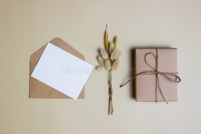 A letter concept with envelope and gift box and rope over the brown background. royalty free stock images