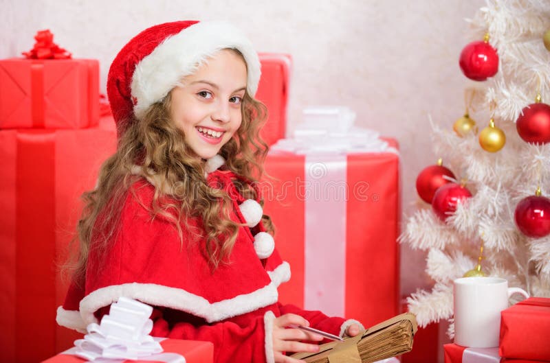 Letter for santa. Wish list. Girl little kid hold pen and paper near christmas tree writing letter. I was good girl all royalty free stock images Letter for santa. Wish list. Girl little kid hold pen and paper near christmas tree writing letter. I was good girl all royalty free stock images