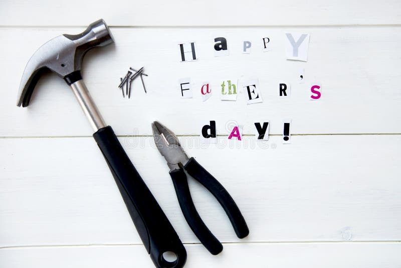 Happy Fathers Day Letters Cut out from Magazine and Tools On White Background. Happy Fathers Day Letters Cut out from Magazine and Tools On White Background