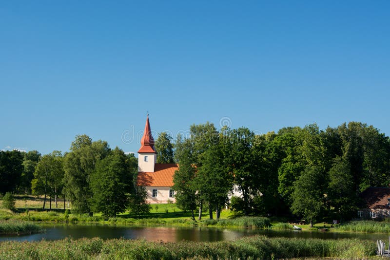 Idyllic Latvian countryside in summer - lutheran church by the Lake Araisi. Idyllic Latvian countryside in summer - lutheran church by the Lake Araisi