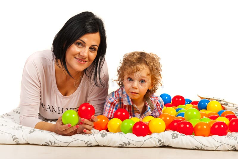 Letto di menzogne del figlio e della madre con le palle fotografia stock