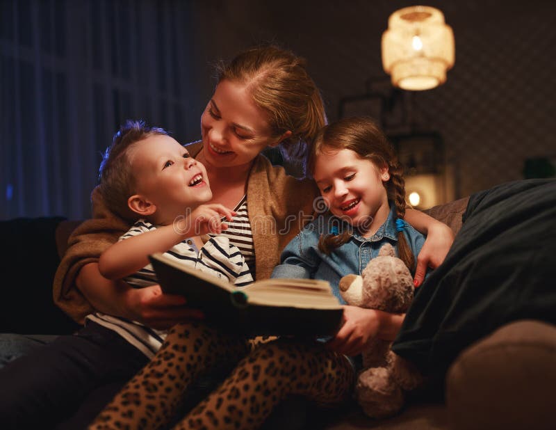 Evening family reading. mother reads children a book before going to bed. Evening family reading. mother reads children a book before going to bed