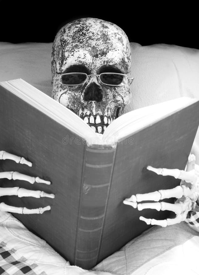 Skeleton reads a book in bed. Skeleton reads a book in bed