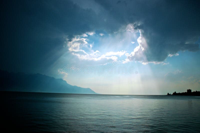 Light shining through the clouds over Lake Geneva (Lac Leman). Light shining through the clouds over Lake Geneva (Lac Leman)