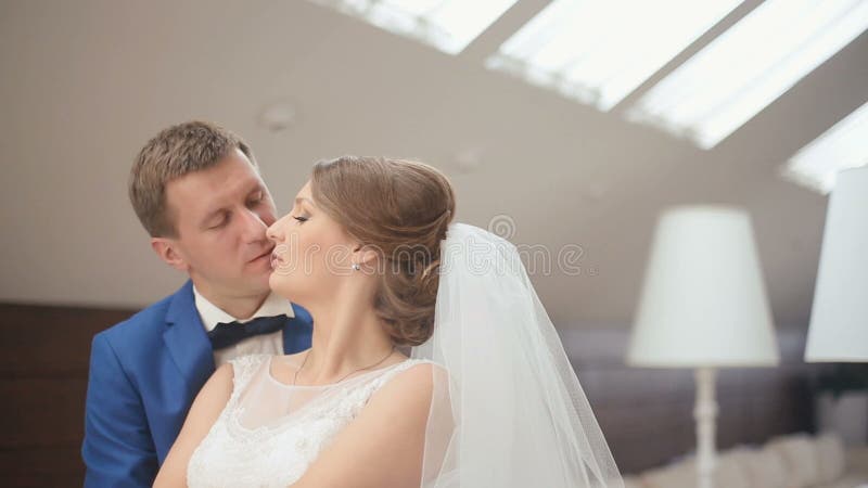 Leuk echtpaar in de luxueuze koffie Close-up teder ogenblik van bruidegom kussende bruid en zacht het glimlachen