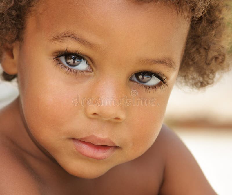 Portrait of cute African American boy with brown skin, big brown eyes, and long eye lashes. Portrait of cute African American boy with brown skin, big brown eyes, and long eye lashes.