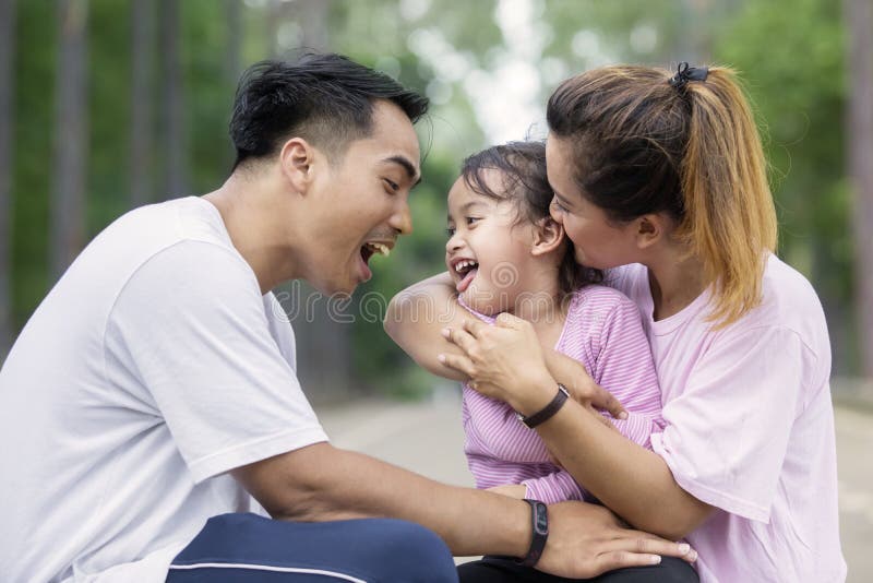 Leuke meisjespelen met haar ouders bij in openlucht royalty-vrije stock fotografie Leuke meisjespelen met haar ouders bij in openlucht royalty-vrije stock fotografie