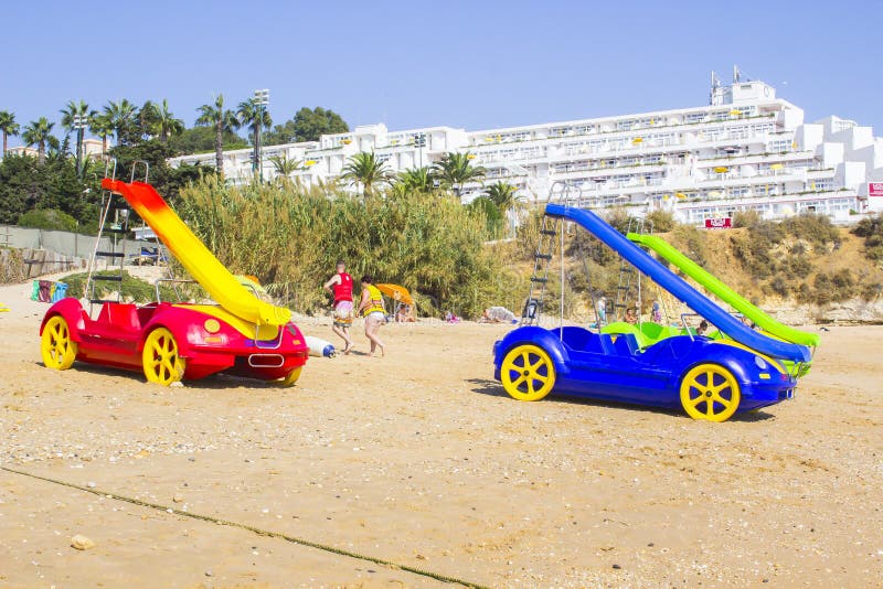 3 October 2018 Fun Pedaloes with water slides parked on the Oura Praia Beach in Albuferia Portugal waiting for the next customers. nature, landscape, colourful. 3 October 2018 Fun Pedaloes with water slides parked on the Oura Praia Beach in Albuferia Portugal waiting for the next customers. nature, landscape, colourful
