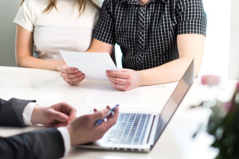 People having meeting about mortgage, bank loan, buying house, insurance or apartment rent. Woman, men and lawyer preparing prenupitial agreement in office. Person reading real estate paper contract. People having meeting about mortgage, bank loan, buying house, insurance or apartment rent. Woman, men and lawyer preparing prenupitial agreement in office. Person reading real estate paper contract.