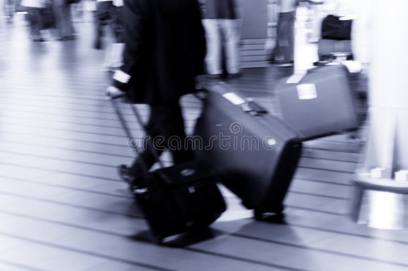 People traveling at the airport ( Used a long exposure for motion blur). People traveling at the airport ( Used a long exposure for motion blur)
