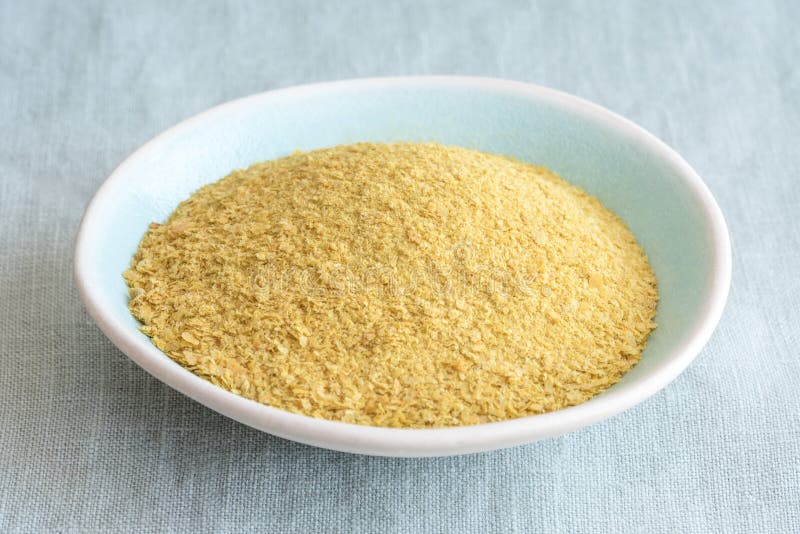 Close up view of nutritional yeast isolated in a bowl. Close up view of nutritional yeast isolated in a bowl