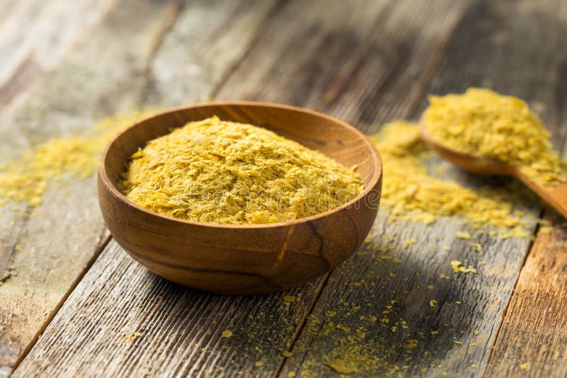 Raw Yellow Organic Nutritional Yeast in a Bowl. Raw Yellow Organic Nutritional Yeast in a Bowl