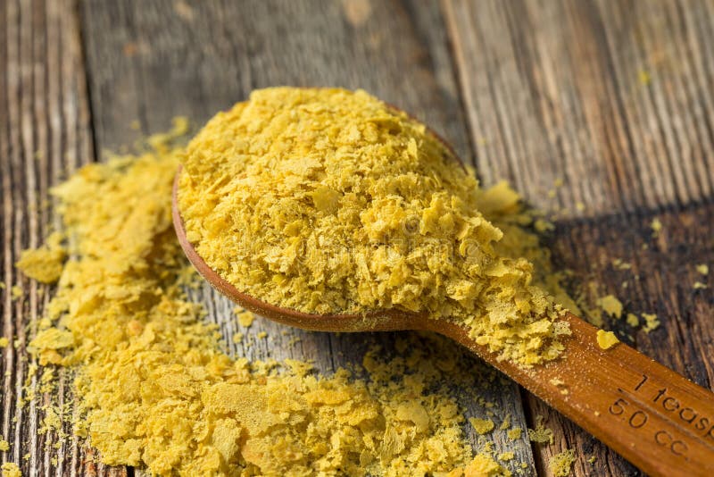 Raw Yellow Organic Nutritional Yeast in a Bowl. Raw Yellow Organic Nutritional Yeast in a Bowl