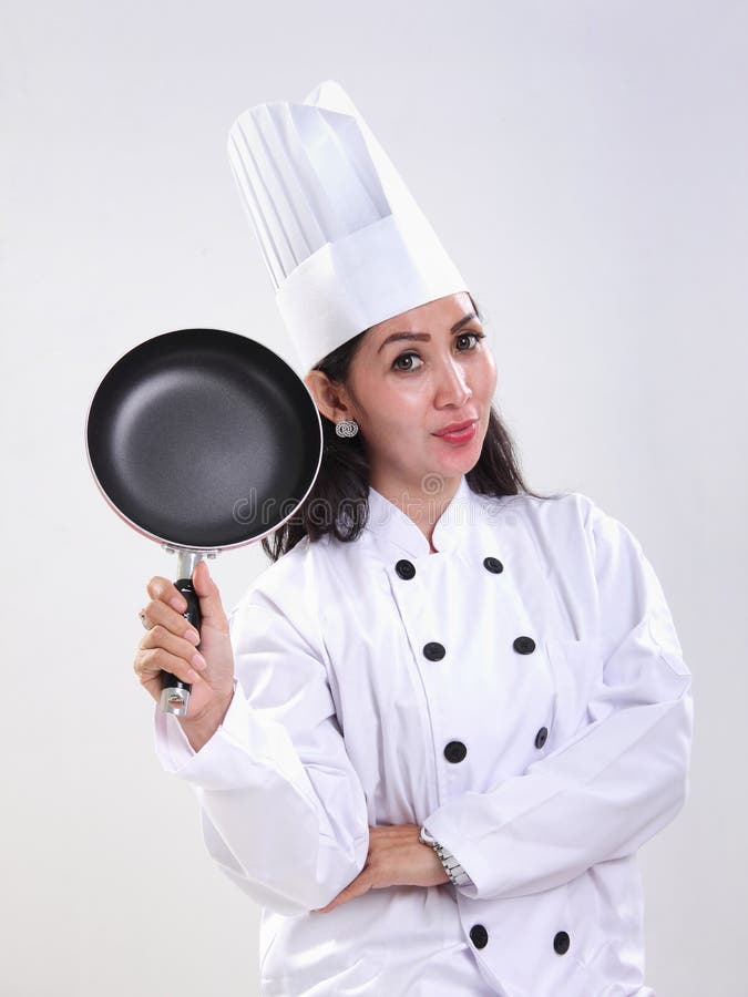 Levantamento fêmea profissional do cozinheiro chefe foto de stock royalty free Levantamento fêmea profissional do cozinheiro chefe foto de stock royalty free
