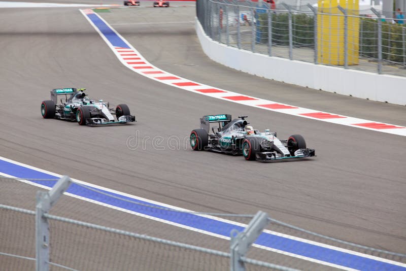 Sochi, Russia - October 11, 2015: Lewis Hamilton of Mercedes AMG Petronas F1 Team leads Nico Rosberg Mercedes AMG Petronas Formula 1 Team at the race of Formula One Russian Grand Prix at Sochi Autodrom. Sochi, Russia - October 11, 2015: Lewis Hamilton of Mercedes AMG Petronas F1 Team leads Nico Rosberg Mercedes AMG Petronas Formula 1 Team at the race of Formula One Russian Grand Prix at Sochi Autodrom.