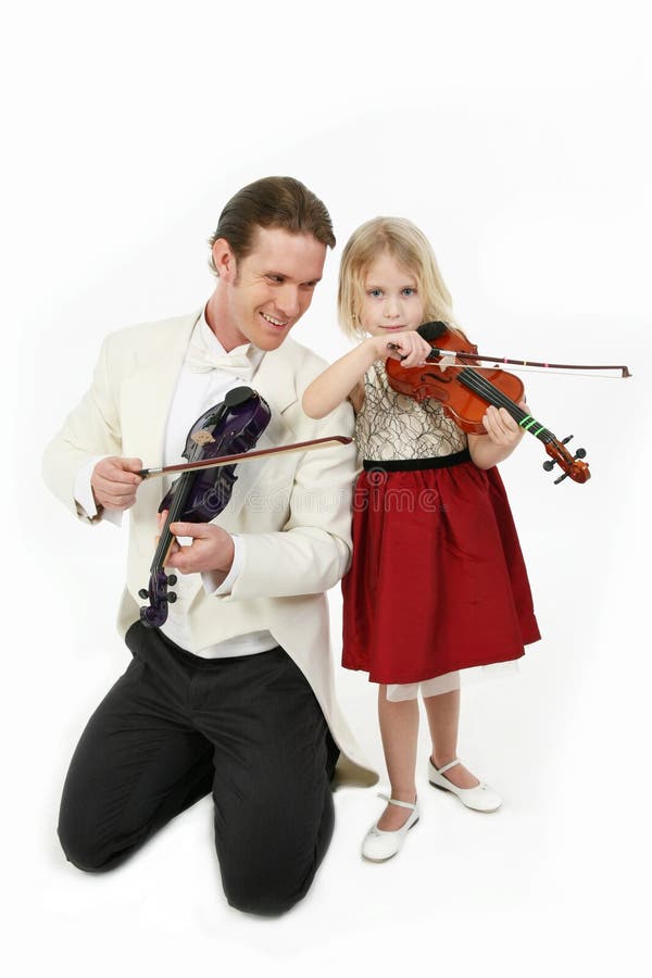 Father or teacher and five year old daughter in formal wear with violins. Father or teacher and five year old daughter in formal wear with violins