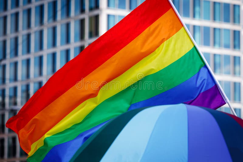 Lgbt pride rainbow flag during parade in the city. Lgbt pride rainbow flag during parade in the city