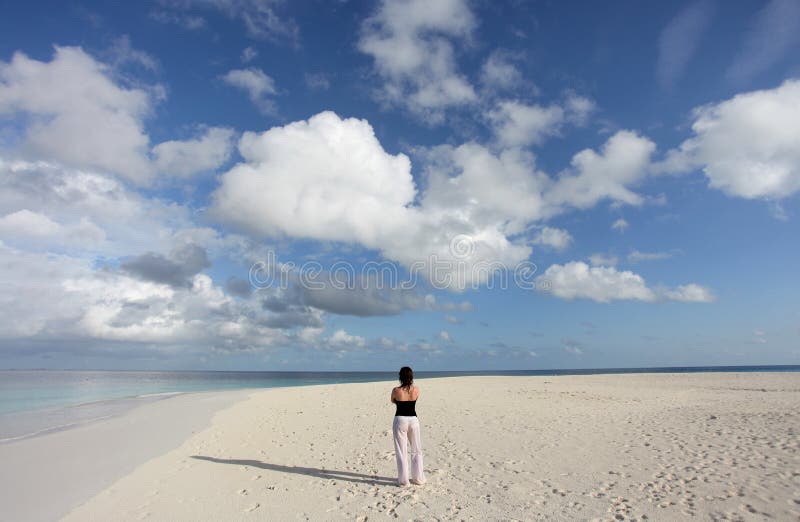 A woman enjoying the silence and freedom of a maldivian island. A woman enjoying the silence and freedom of a maldivian island