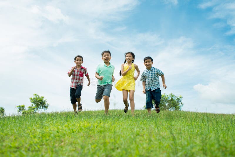 Groups of children enjoying summer freedom running across the lawn. Groups of children enjoying summer freedom running across the lawn