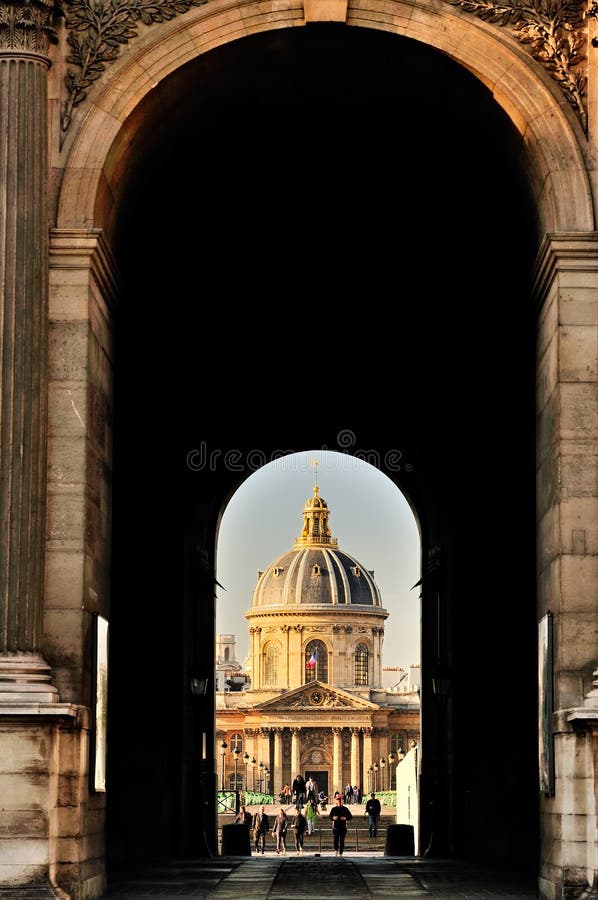 A picture of the library Mazarine in Paris (France) taken through a gate of the Louvre. A picture of the library Mazarine in Paris (France) taken through a gate of the Louvre.