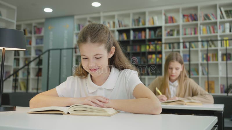 Libro di lettura di una studentessa felice in classe