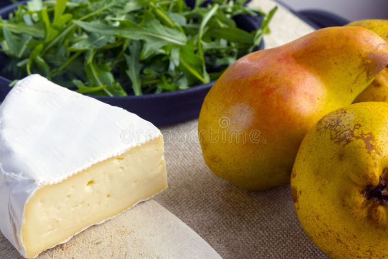 Lichte de zomersalade met peer Ingrediënten: arugula, peer, Briekaas, pijnboomnoten, honingssaus royalty-vrije stock afbeelding Lichte de zomersalade met peer Ingrediënten: arugula, peer, Briekaas, pijnboomnoten, honingssaus royalty-vrije stock afbeelding