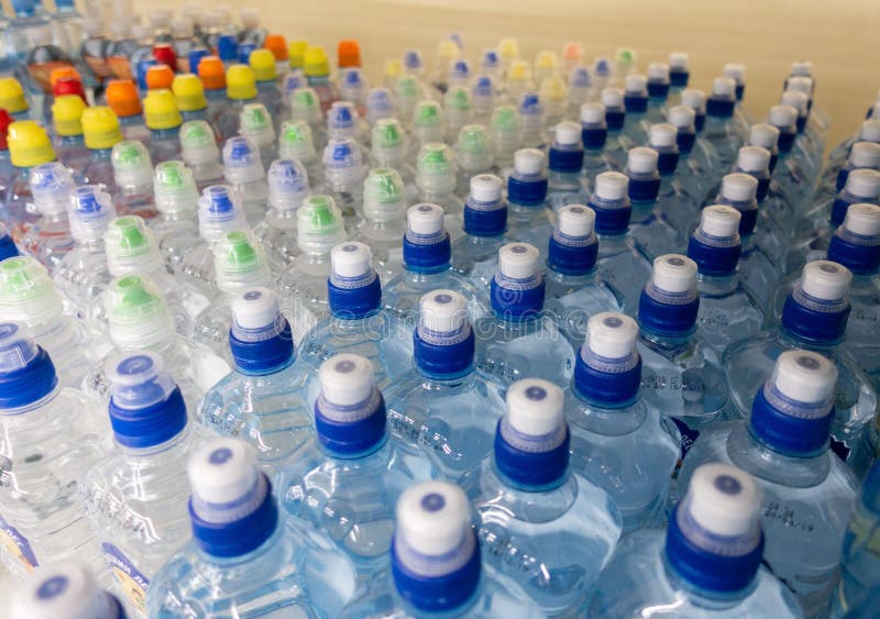 Lid Plastic Water Bottle in the Market. Multicolored Plastic Bottle