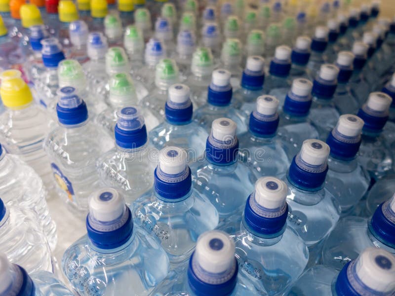 Lid Plastic Water Bottle in the Market. Multicolored Plastic Bottle