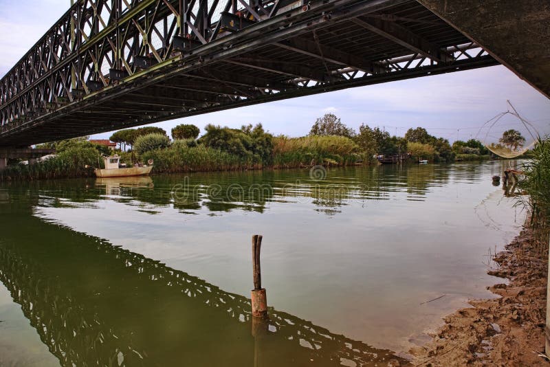 Lido di Dante, Ravenna, Emilia Romagna, Italy: the old Bailey bridge built during the second world war crossing the river near the Adriatic sea beach. Lido di Dante, Ravenna, Emilia Romagna, Italy: the old Bailey bridge built during the second world war crossing the river near the Adriatic sea beach