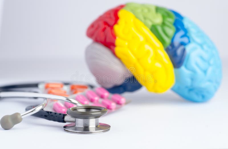 Love your brain/mental health concept shot in a studio - stethoscope, a colorful brain model and pills. Love your brain/mental health concept shot in a studio - stethoscope, a colorful brain model and pills.