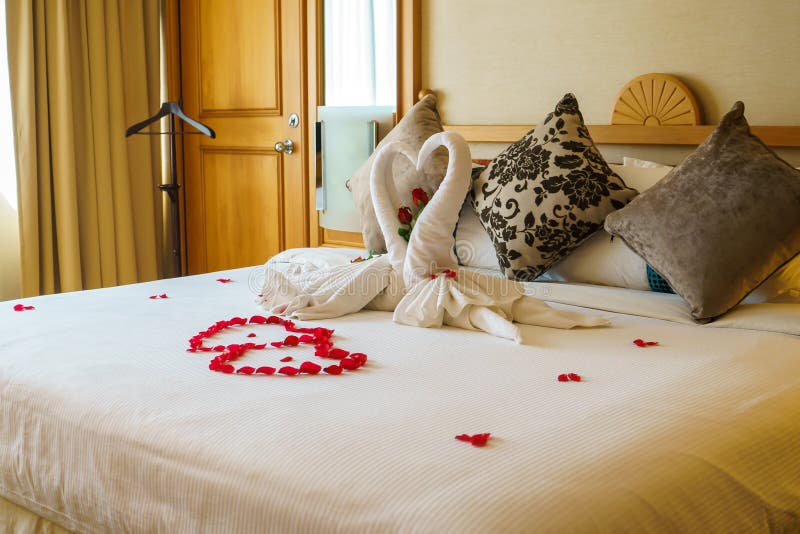 Love swan and flower petal decoration on the bed. Love swan and flower petal decoration on the bed.