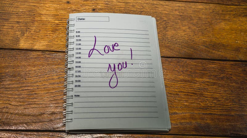 Love you, writing love text on paper, lovely message. Text on spiral agenda. Romantic, love concept. Valentine`s day. Love you, writing love text on paper, lovely message. Text on spiral agenda. Romantic, love concept. Valentine`s day