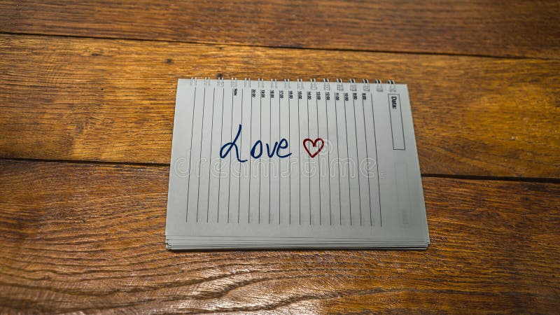 Love, writing love text on paper, lovely message. Text on spiral agenda. Romantic, love concept. Valentine`s day. Love, writing love text on paper, lovely message. Text on spiral agenda. Romantic, love concept. Valentine`s day