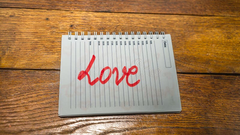 Love, writing love text on paper, lovely message. Text on spiral agenda. Romantic, love concept. Valentine`s day. Love, writing love text on paper, lovely message. Text on spiral agenda. Romantic, love concept. Valentine`s day