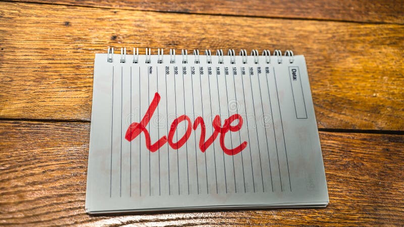 Love, writing love text on paper, lovely message. Text on spiral agenda. Romantic, love concept. Valentine`s day. Love, writing love text on paper, lovely message. Text on spiral agenda. Romantic, love concept. Valentine`s day